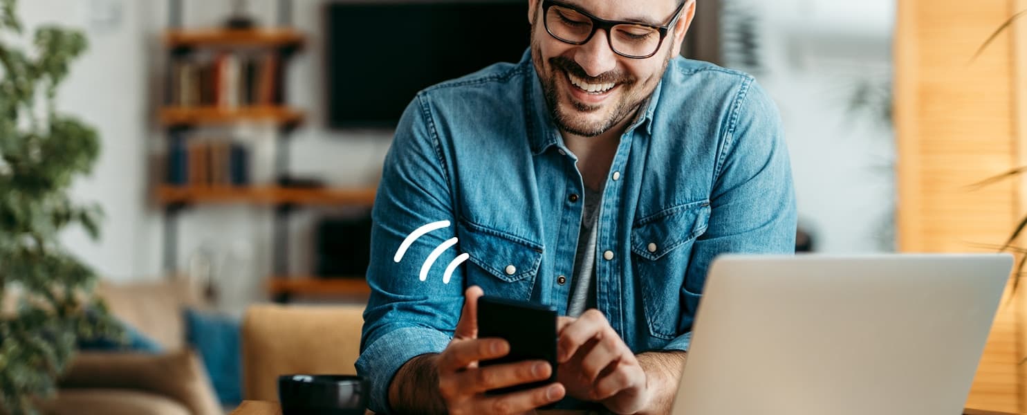 picture of a person using a laptop and a phone