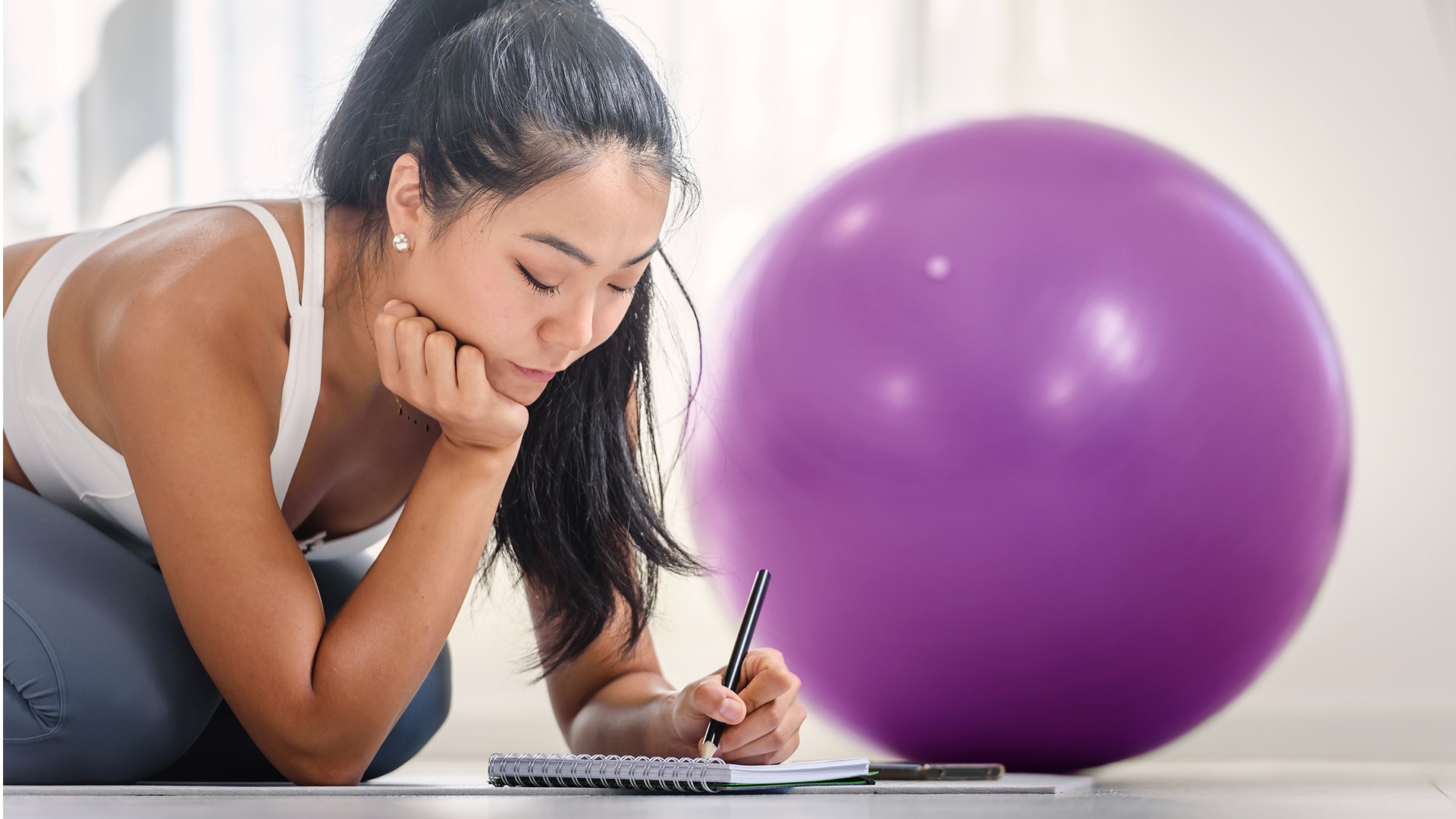 Person writing down goals for the new year.