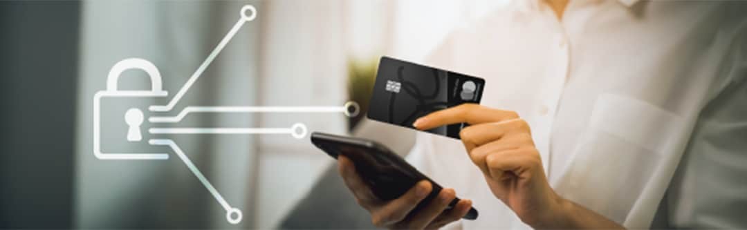 Illustration – Digital lock with facets pointing toward credit card, mobile device etc,  Client using mobile device with PC Mastercard in hand.