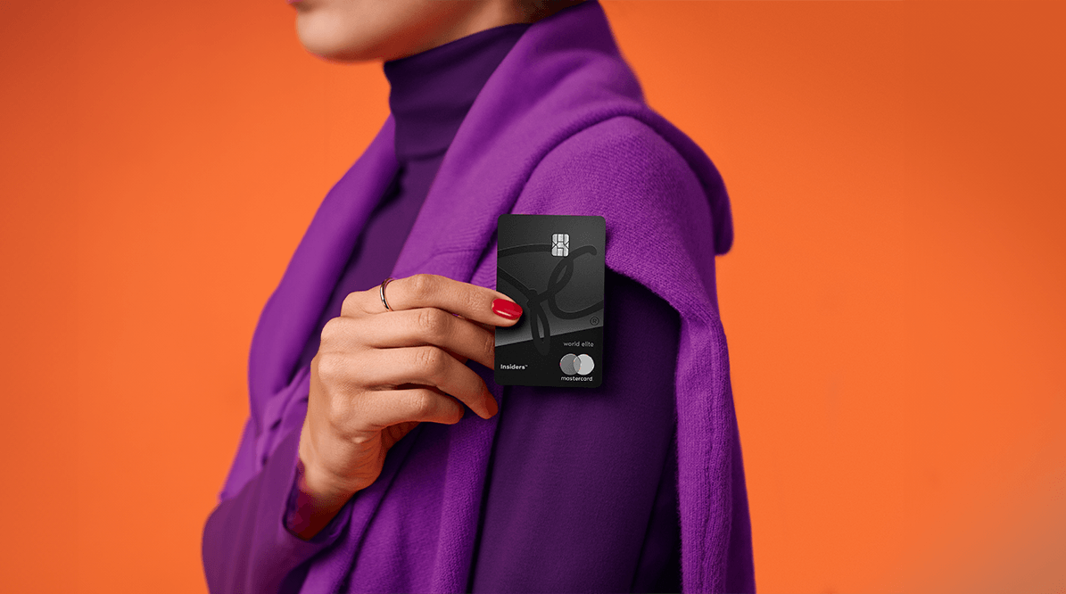 A persons hand holding a PC Insiders™ World Elite® Mastercard®